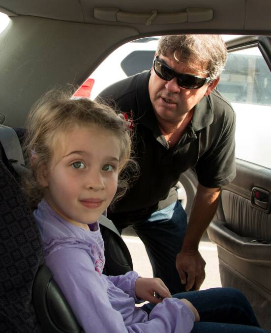 CHECK: Young Leeton resident Heidi Arel has her restraint checked by approved fitter Tom Annetts. 