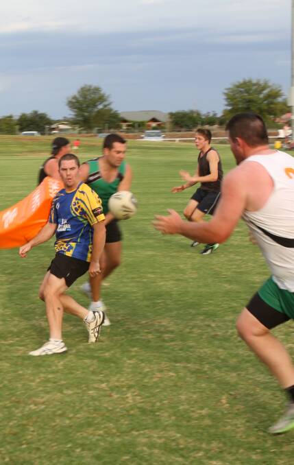 WORK OUT: Brad McDonell (left) fires out a pass under pressure during Greens preseason training in preparation for the West Wyalong knockout. 