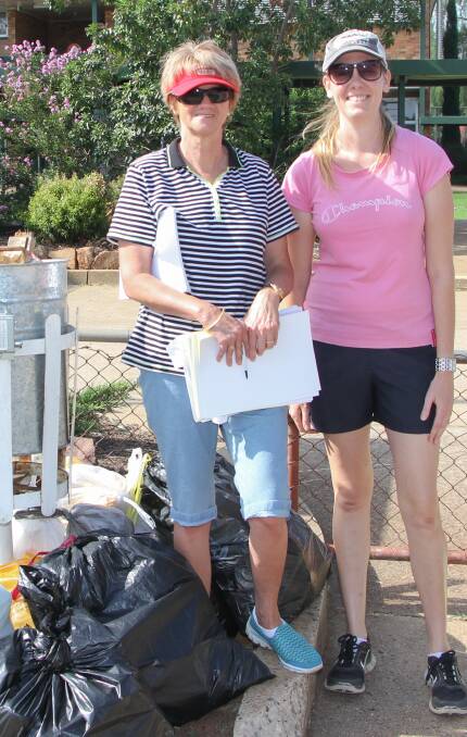 Judy McGrath and Karla Brady help clean up the town. 