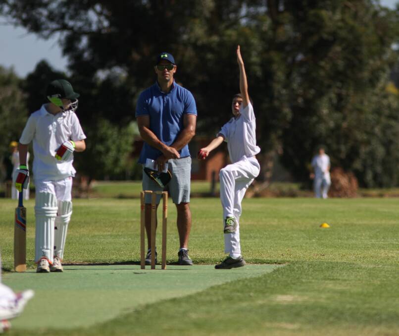DELIVER: Byron Tarlinton sends down a ball in a recent junior cricket under 14s match at the Leeton High School ovals. 