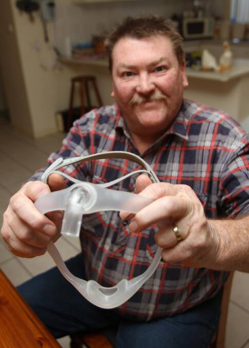 LEETON resident Noel Buchan shows the under-the-nose CPAP mask he wears to bed since being diagnosed with severe sleep apnoea.