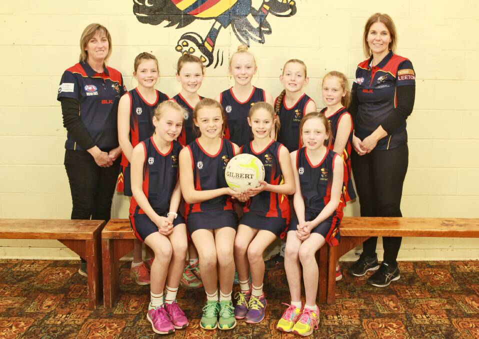 The Crows under 11s netballers and coaches.