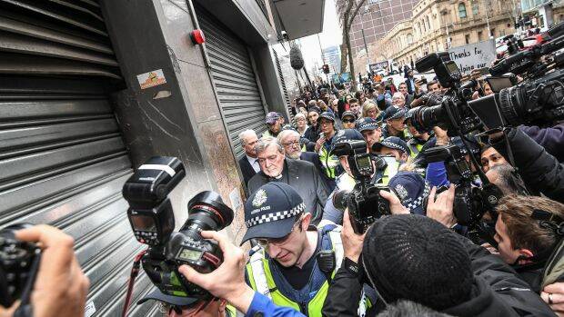 Surrounded by the world's media, Cardinal George Pell leaves the Melbourne Magistrates Court on Wedensday. Photo: Justin McManus

