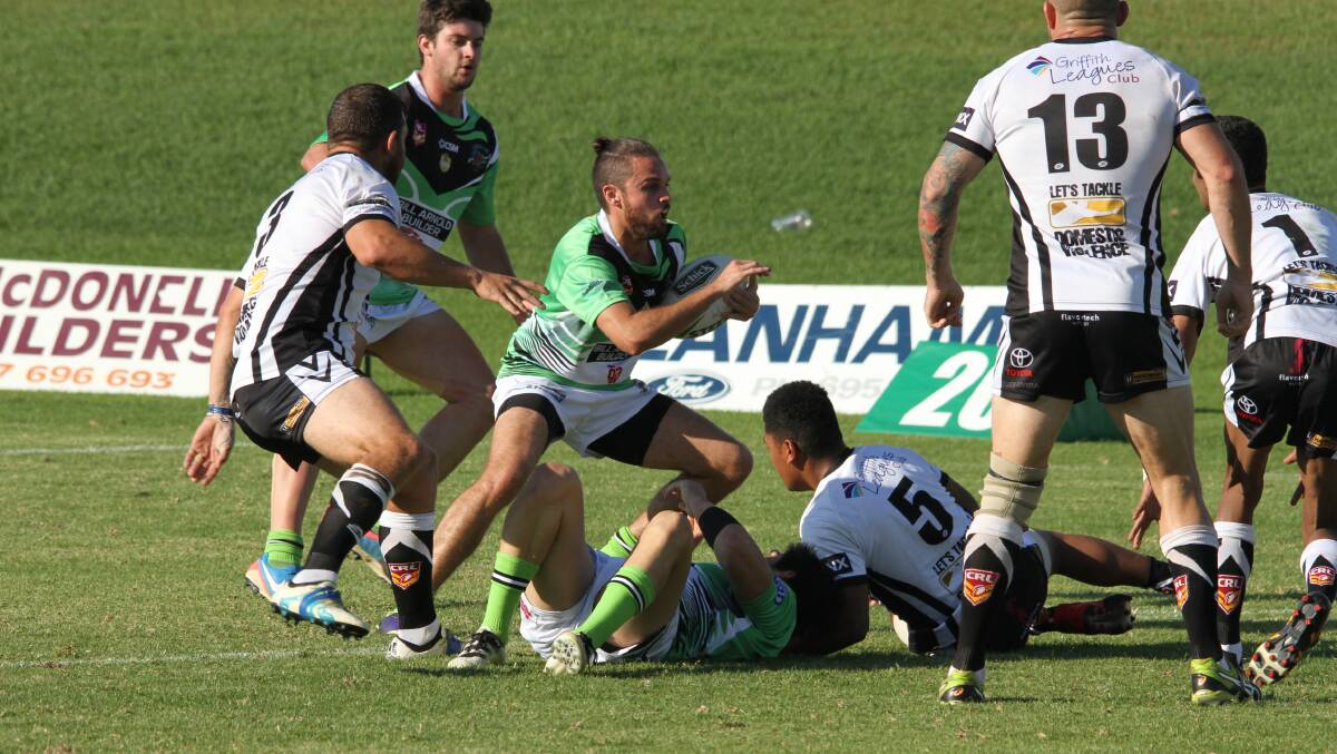 STEPPING THROUGH: Greens' Dylan Ingram attempts to find his way past the Black and Whites defensive line last weekend. PHOTO: Ron Arel