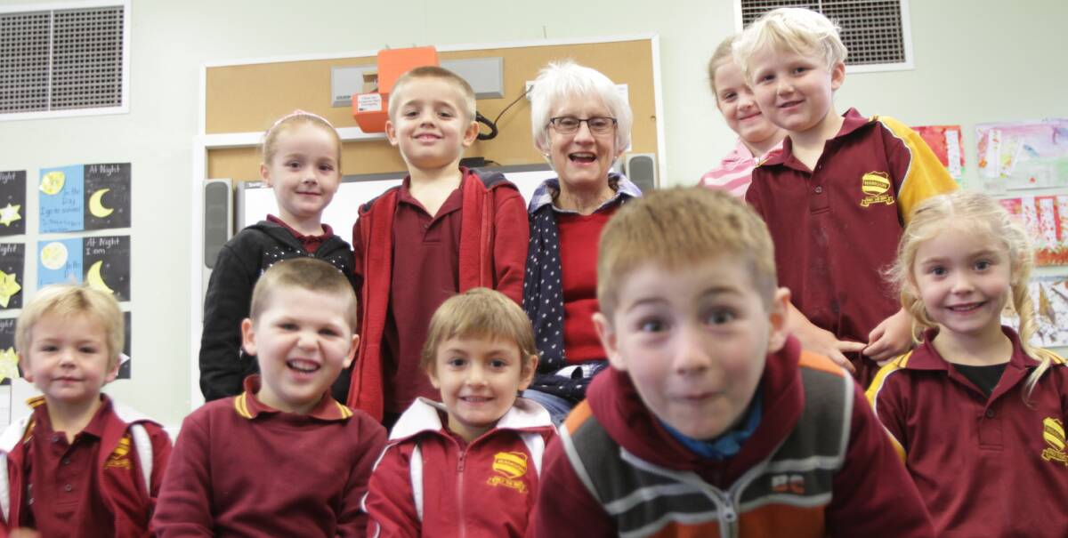 SAD TO SAY GOODBYE: Anne Morshead surrounded by her adoring kindergarten/1 students. 
Picture: Riley Krause.