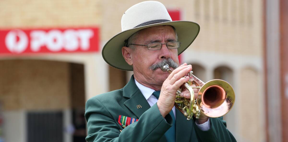 PLAY: Leeton Town Band member Ian Bull sounds the Last Post during Wedneday's Rembrance Day service. Picture: Anthony Stipo