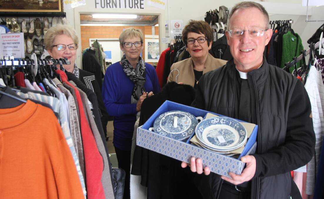 SALE: St Peter's Anglicare Op Shop volunteers (from left) Kay Marks, Joan Marks and Gayle Patten with Father Robert Murphy ahead of National Op Shop Week. 