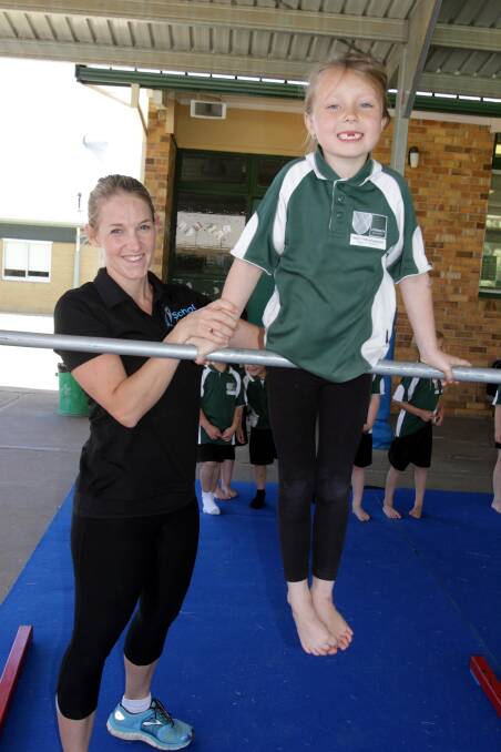 Instructor Mel Collier with Chloe Dunbar (year 1) during last Friday's gymnastics sessions. 