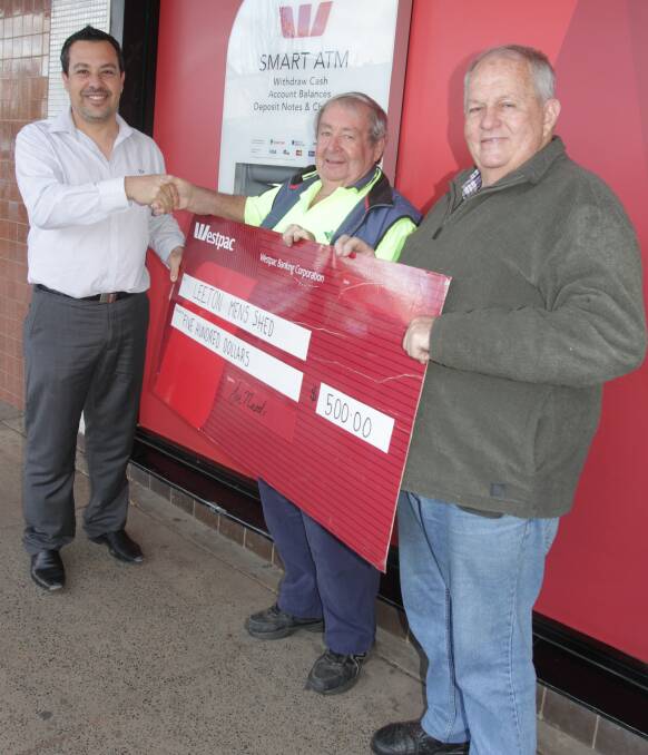 HELPING HAND: Westpac Leeton branch manager Joe Nardi donates $500 to Leeton Men's Shed member Mick Smith and vice chairman Ian Errey.