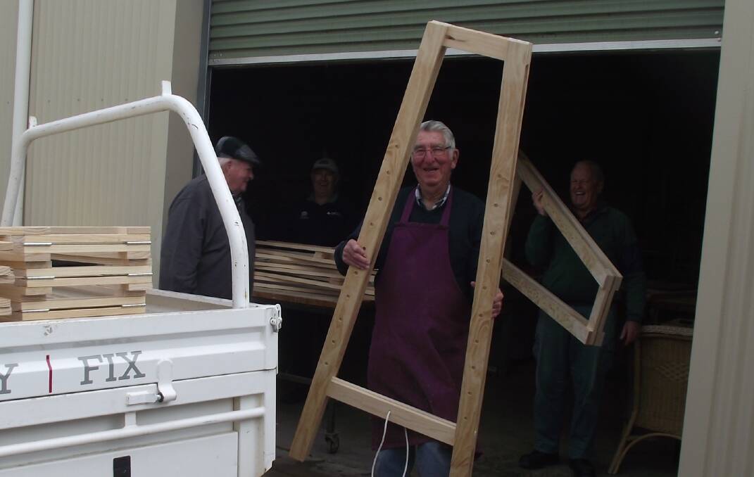 HARD WORK: Leeton Men's Shed member Garry Chambers loads one of 25 easels.