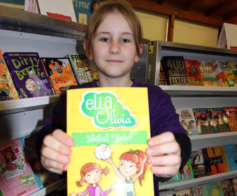 HELPING OUT: Parkview Public School student Ruby Miller, 8, was on hand this week to not only assist at the book fair, but pick up a purchase or two of her own. 