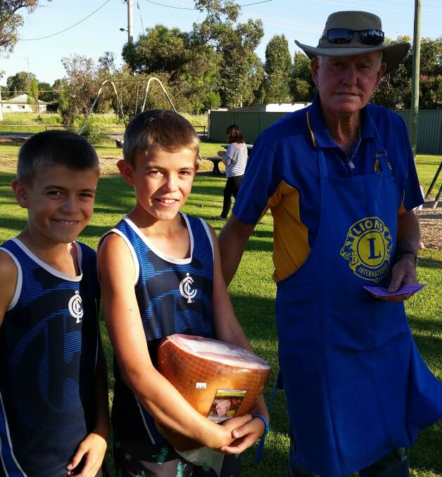 DINNER: Ryan brothers Jaxon and Blake with Yanco Lions Club president Buster Ryan after winning at the hams carnival last year.