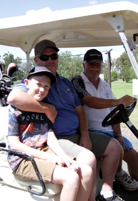 TAKING PART: Sebastian, 13, Tony and Don Piltz enjoy the annual MS Charity Golf Day at the Leeton golf course recently. 