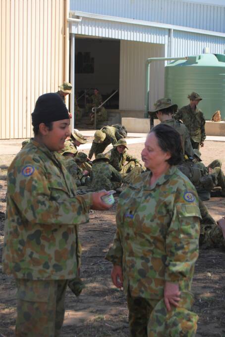 Leeton Cadet Karamveer Kang discusses Cadet rations with Helen Patton from Goulburn’s Trinity Catholic College Army Cadet Unit during a break at the indoor firing range at Singleton. Photo: Cadet Jack Seaman