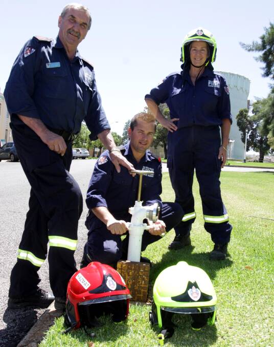 HELP: Captain Graham Parks, Matt Deaton and Wendy Horton encourage residents to clear away areas surrounding hydrants. They also have new high-tech helmets. 