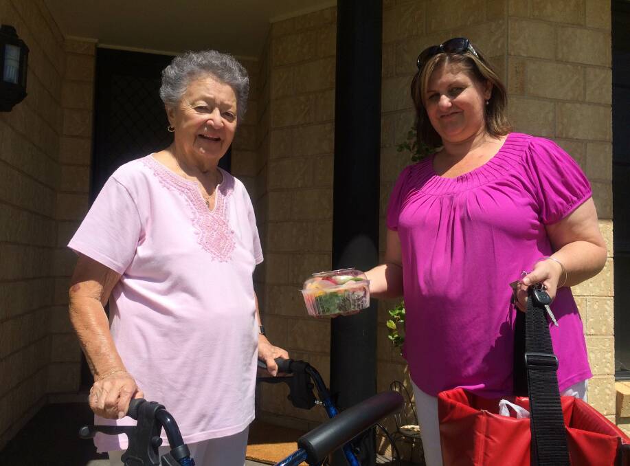 GOOD NEWS: Meals on Wheels client Betty Hamilton (left) receives her meal from HACC co-ordinator Tanya Lewis. Funding has been extended for these programs.  
