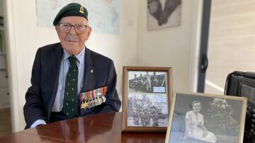 At 103-years-old, World War II veteran John Wilkinson, who lives in Leeton, has reflected on his service. Sgt Major Wilkinson is pictured with photographs from his time in New Guinea, as well as his late wife Joan. Picture by Talia Pattison
