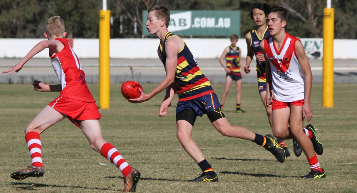 OPTIONS: Leeton-Whitton's under 15s player Reece Grundy fires off a hand ball during a recent clash with Griffith. 