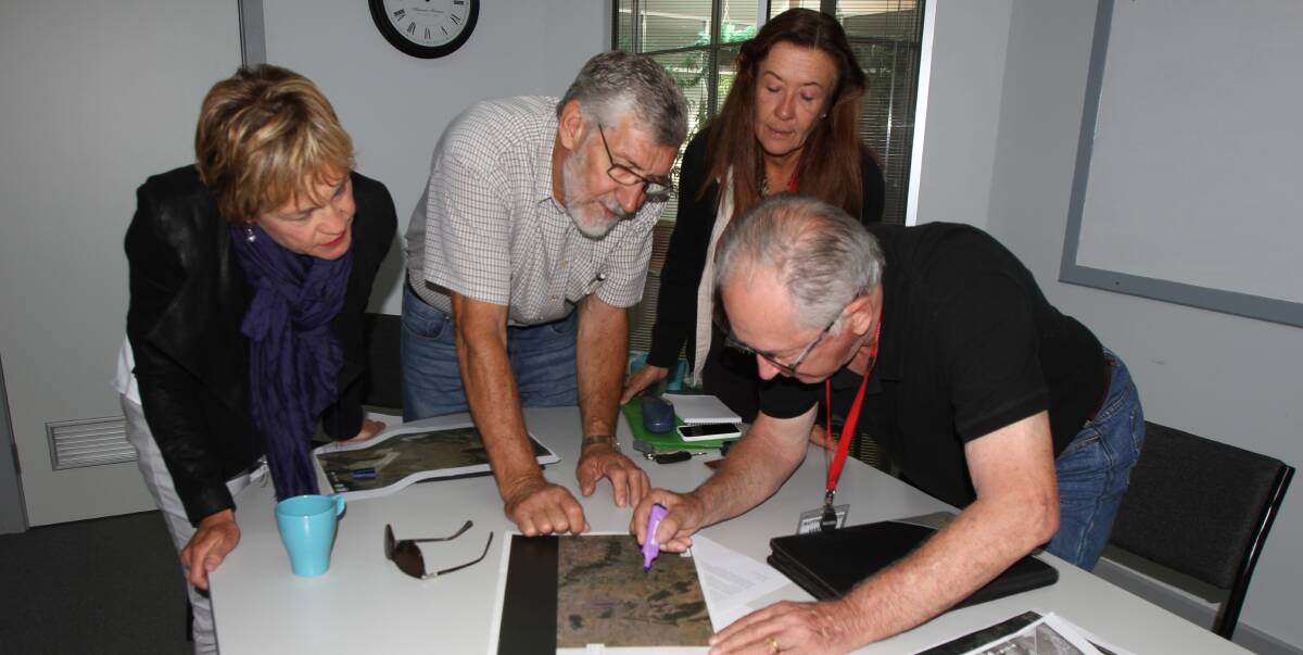 INVESTIGATE: Ron Pike (right) shows the water storage plan to (from left) independent candidate for Murray Helen Dalton, mayor Paul Maytom and Murrumbidgee Valley Food and Fibre Association president Debbie Buller. 