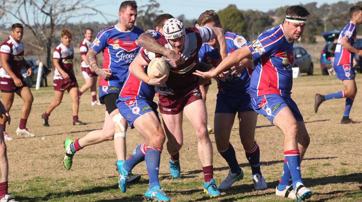 HELP UP: Yanco-Wamoon's Codey Parsons tries to make his way through the Darlington Point-Coleambally defence on Sunday. Photo: Anthony Stipo 