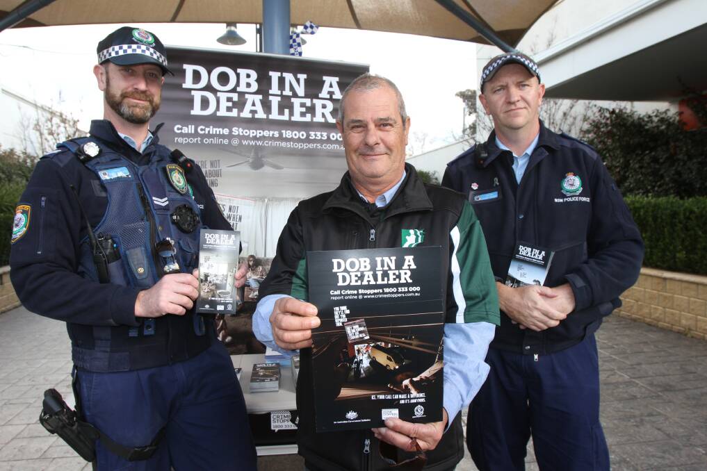 HELP OUT: Griffith LAC police officers Marc Roberts (left) and Stuart Browne (right) with Mark Norvall urge residents to "dob in a dealer". Photo: Hannah Higgins 