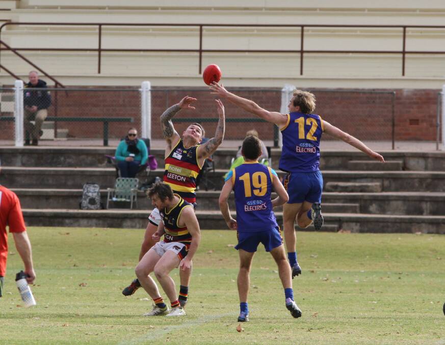 GO FOR IT: Leeton-Whitton's Jade Hodge and Narrandera's Jarred Lane do battle last weekend. Hodge has called for more consistency from his side. Photo: Ron Arel