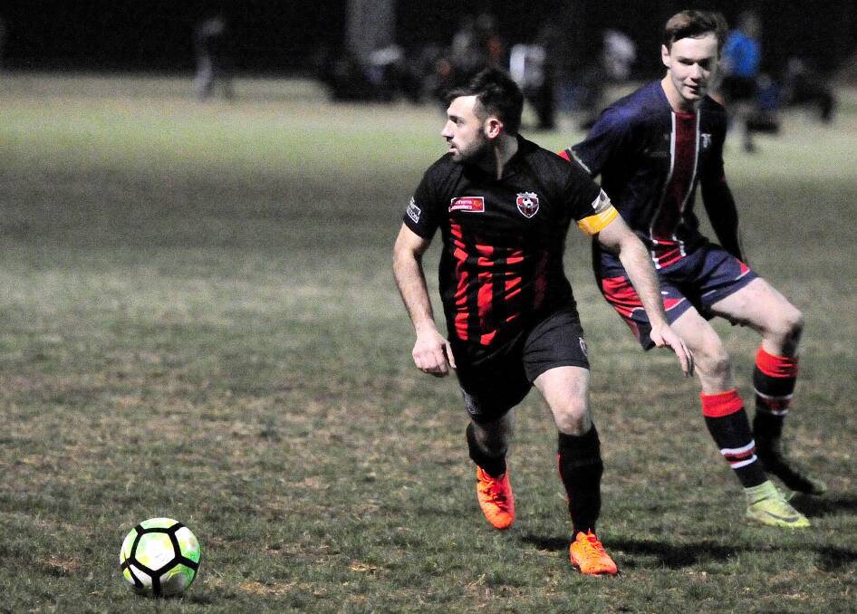 WHERE TO FROM HERE: Leeton United captain Joey Fondacaro looks to see which team mate he can get the ball to during Saturday's loss to Henwood Park. 