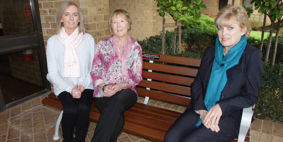 TRIBUTE: Jan Cathcart's sisters Pam Young (left) and Sue Naumann with Rice Marketing Board chairman Robyn Clubb on the chair unveiled in Jan's honour. Photo: Talia Pattison 