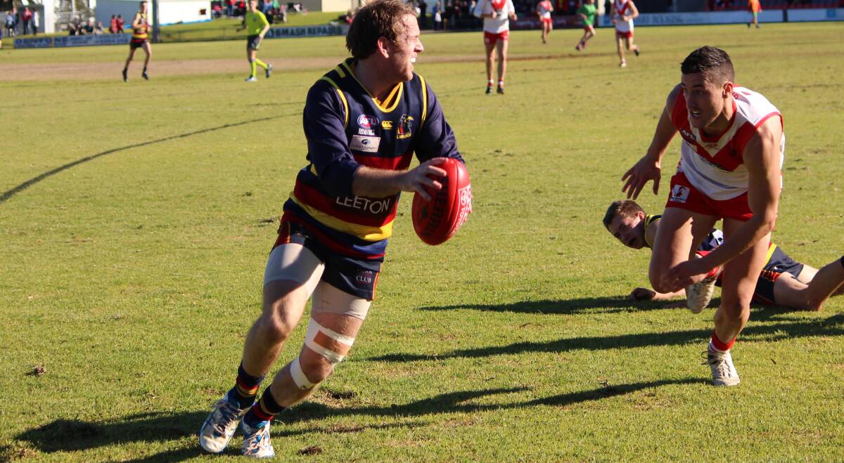 SEARCH: Toby Conroy looks to offload a kick to a Leeton-Whitton team mate inside 50 during the side’s last outing against Griffith. 