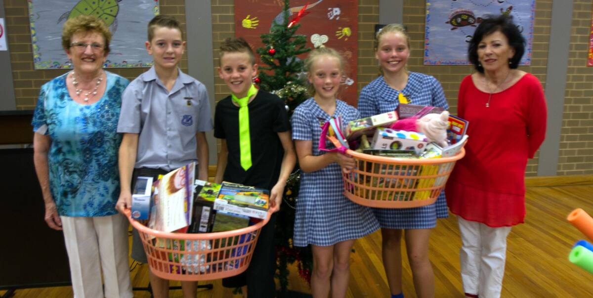 CARING: Marie Eason (left) and Margaret Hogan (right) with LPS leaders Riley Arnold, Jhie Deaton, Lilly Hillier and Charlotte Rudd with some of the toys and items that were donated. 