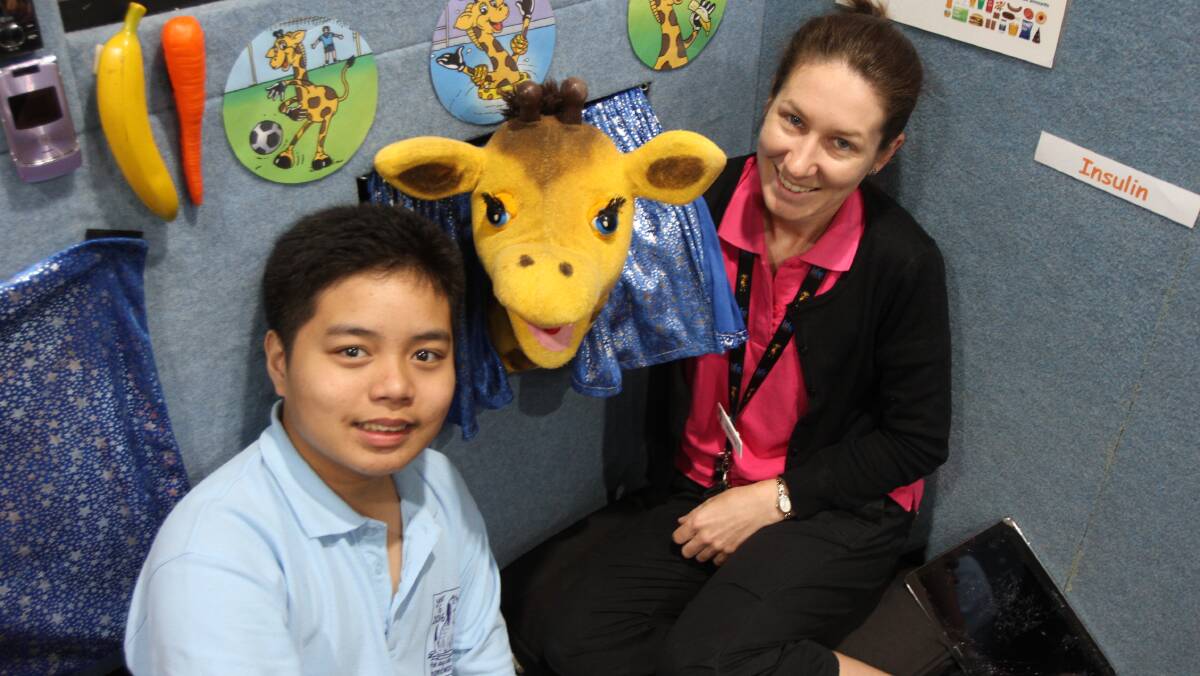VISIT: St Joseph's Primary School student Yuan Manguilmotan, 12, with Healthy Harold and educator Michelle Crowther. 