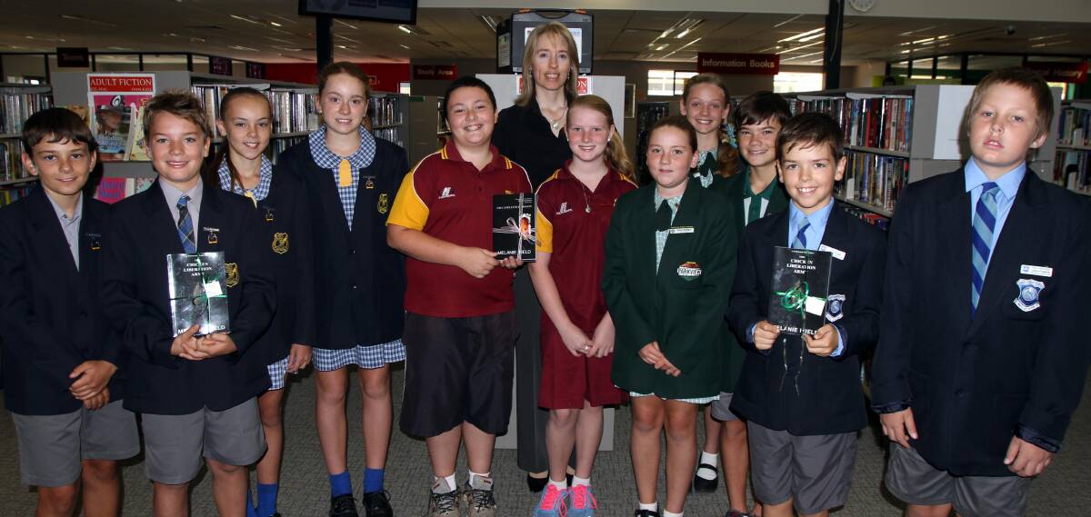 BOOK WORMS: Leeton author Melanie Ifield (back) presents her work to students from Leeton shire's public schools, as well as the town library.