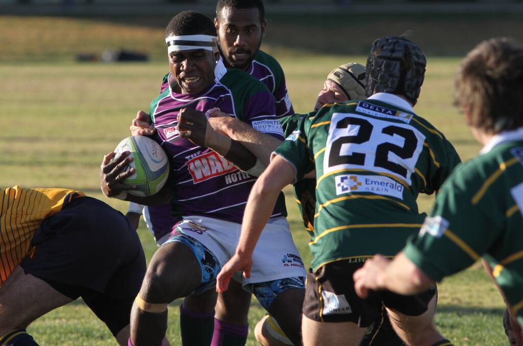 BREAKING THROUGH: Petero Taitusi works hard to move the ball away from the Ag College defence on Saturday in the Phantoms 65-10 victory. 