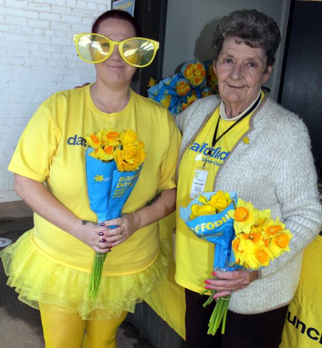 YELLOW PRIDE: Daffodil Day street stall organisers Jodie Salerno (left) and Meryl Parker dressed to impress on Friday. 