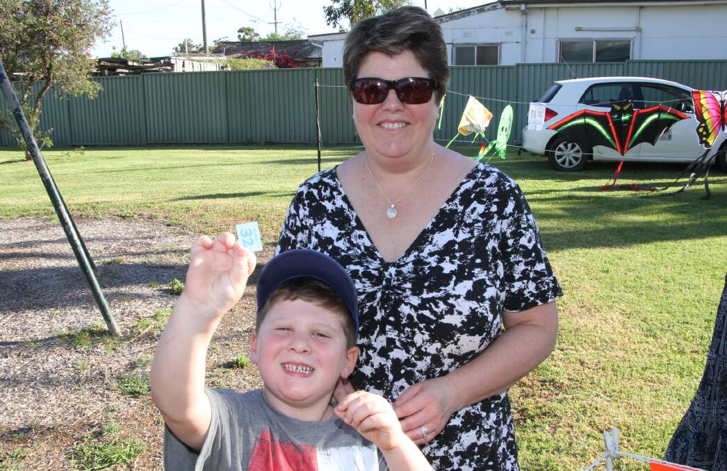 HUGE SMILES: Christopher, 5, and Charlene Binder await the next spin of the wheel for the Yanco Lions Club ham raffle. Photo: Ron Arel