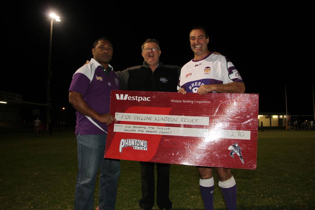 DOING EVERYTHING THEY CAN: Phantoms coach Seru Rogo and Phantoms club president Bart Challacombe present Leeton's Garry Lanham with a cheque for over $5000 to help Fijians recover from Cyclone Winston. Photo: Ron Arel