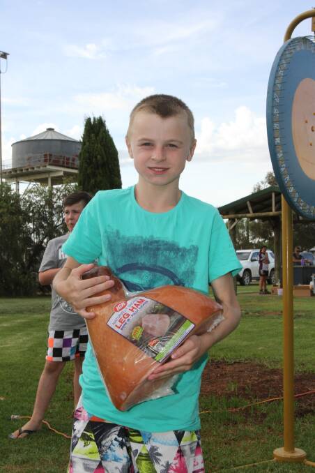 HAMMING IT UP: Brendon Looby, 11, was the evening's first winner at Whitton, taking home a chicken and a ham that he felt was "as big as I am". Photo: Ron Arel