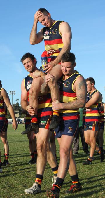 VICTORY LAP: Crows Neil Irwin annd Jade Hodge carry Ben Curley off the field after a massive 104-point win over GGGM. Photo: Ron Arel