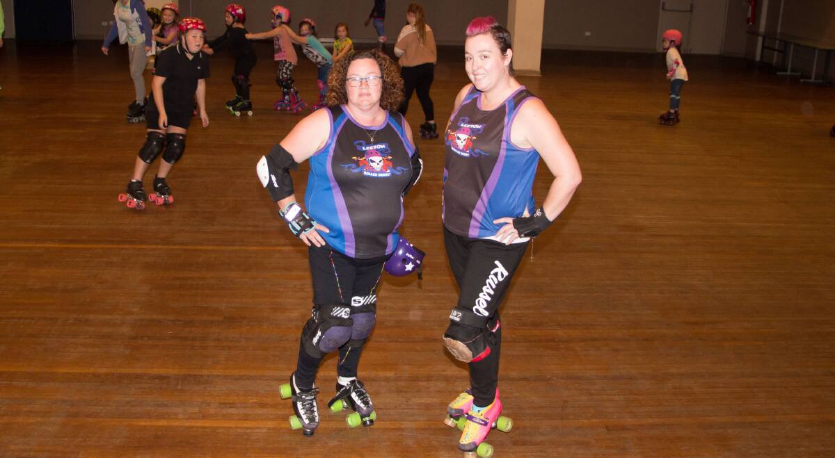 ROLL ON: Leeton Roller Derby's Linda Newman and Sheree Cameron take a break while a session is conducted behind them. Photo: Ron Arel