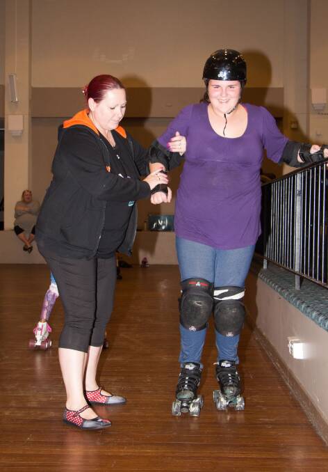 LEARNING TO FLY: Ally Moller receives some one-on-one time from Leeton Roller Derby's Jodie Salerno learning how to skate.