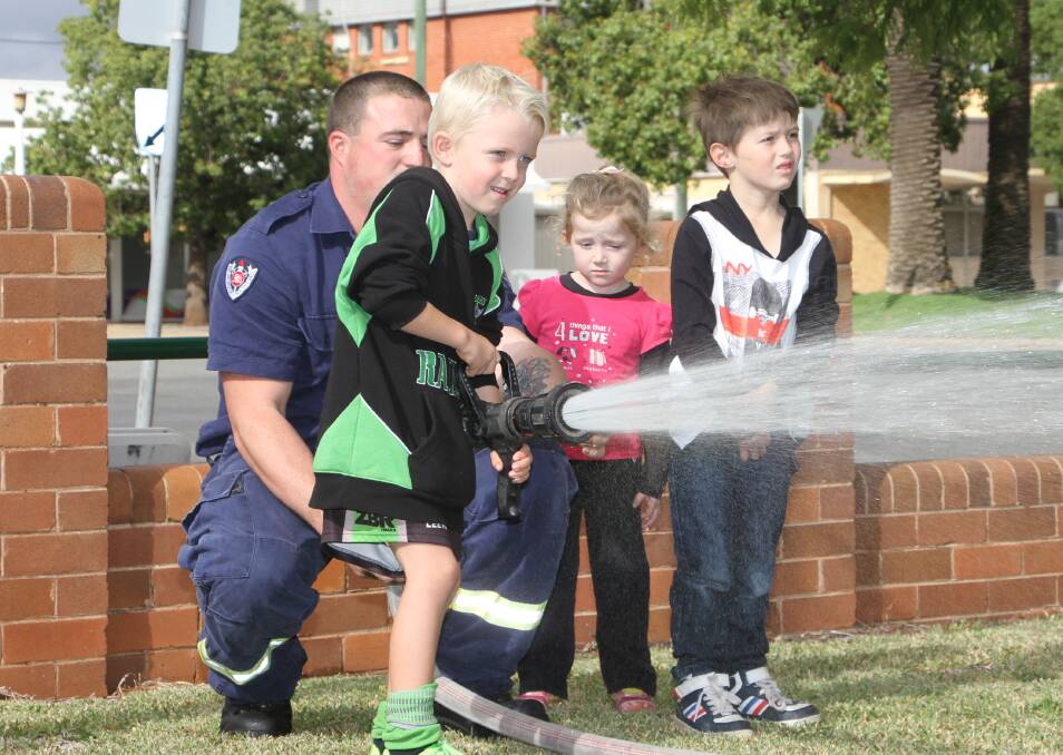 FUTURE FIREFIGHTER: Vann Trembath, 6, gives it his best in washing out imaginary fires. Photo: Ron Arel