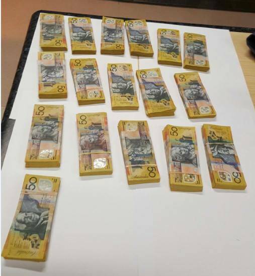 The cash allegedly seized by police following a car crash in Mendooran. Photo: NSW POLICE FACEBOOK