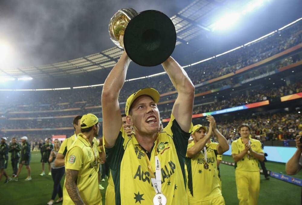 Man of the match James Faulkner celebrates with the World Cup trophy on Sunday.  Photo: Ryan Pierse