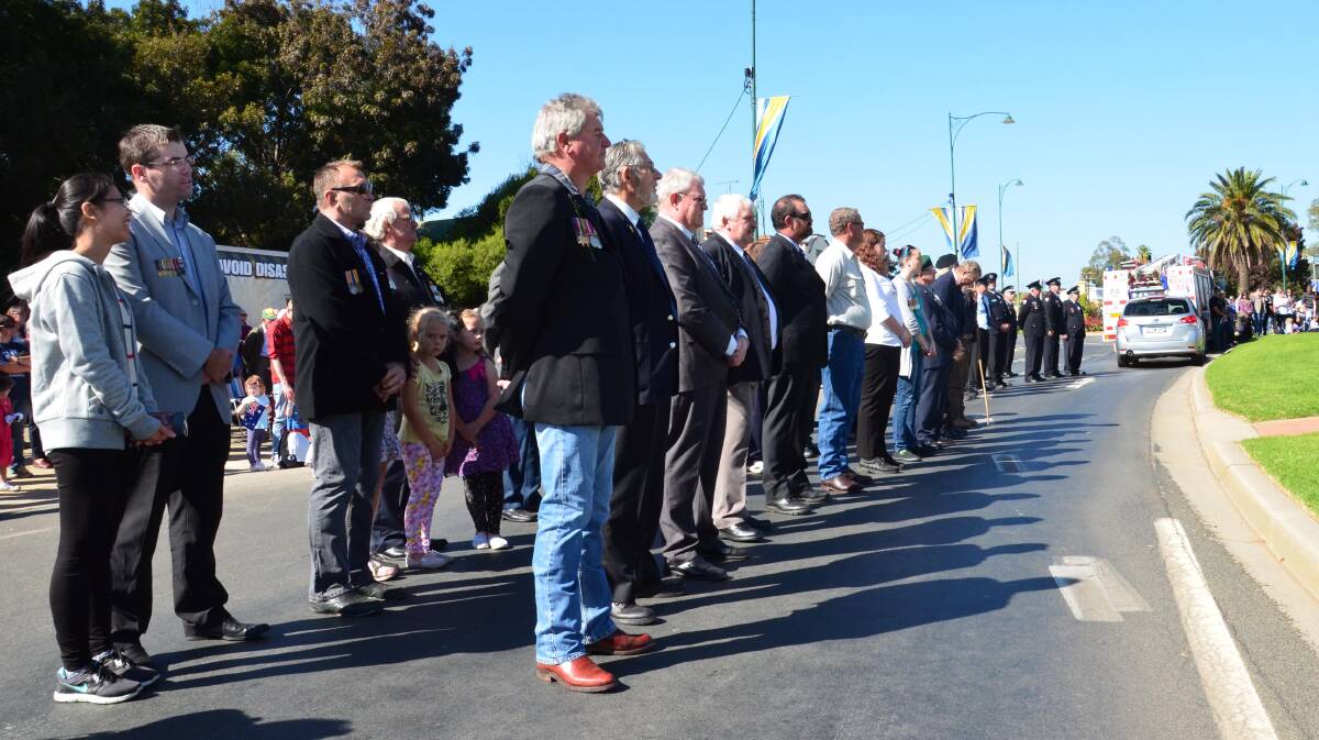 Anzac Day in Junee. Veterans stand at attention. Picture: Declan Rurenga 
