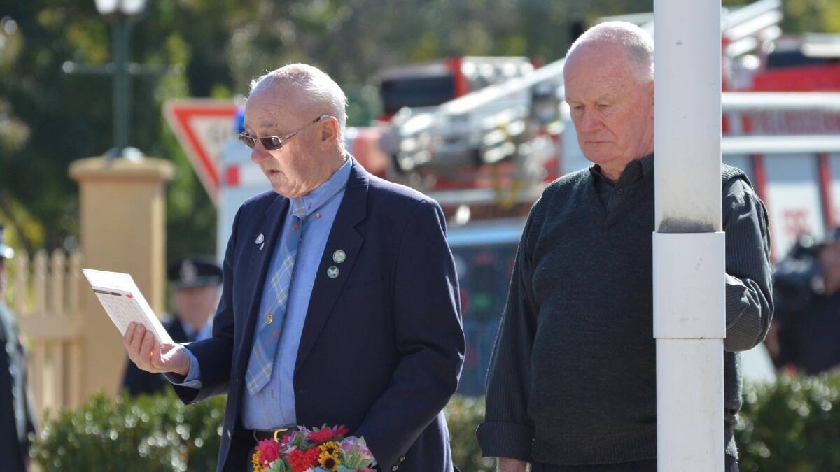 Anzac Day in Junee. Roger Quine and Peter Mack remember railway workers killed during the war. Picture: Declan Rurenga 