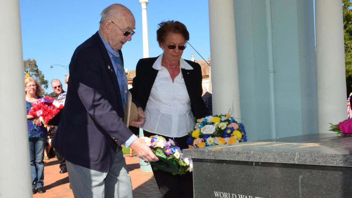 Anzac Day in Junee. Roger Quine and Lola Cummins lay a wreath for Junee Rotary. Picture: Declan Rurenga 