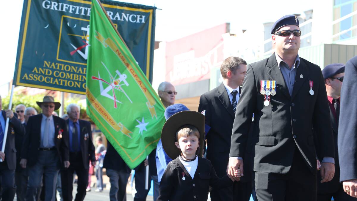 Anzac Day in Griffith. Lindsay Flack and his son Austin, 5. Picture: Anthony Stipo 