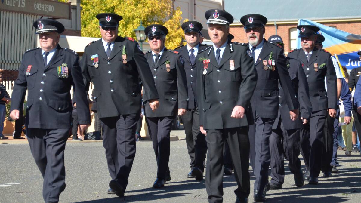 Anzac Day in Junee. Junee firefighters lead the Anzac Day march. Picture: Declan Rurenga 