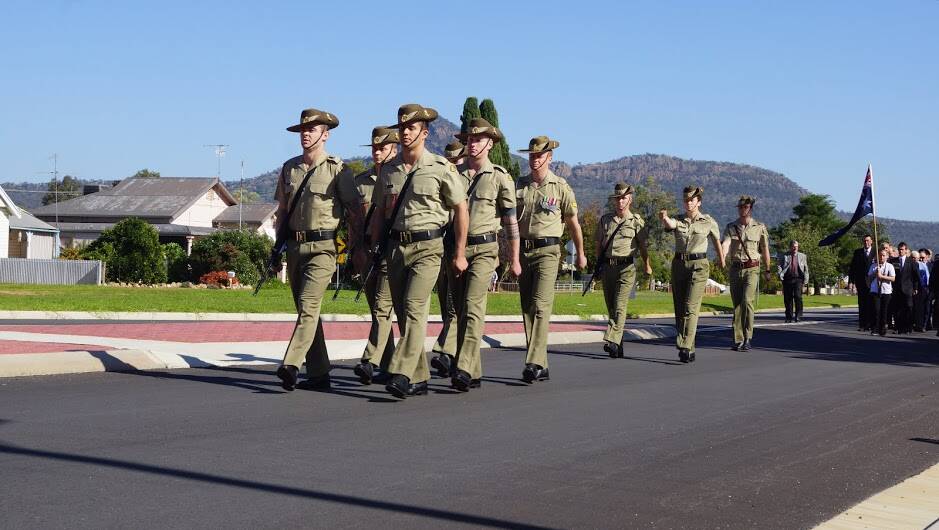 Military personnel lead the march at The Rock.