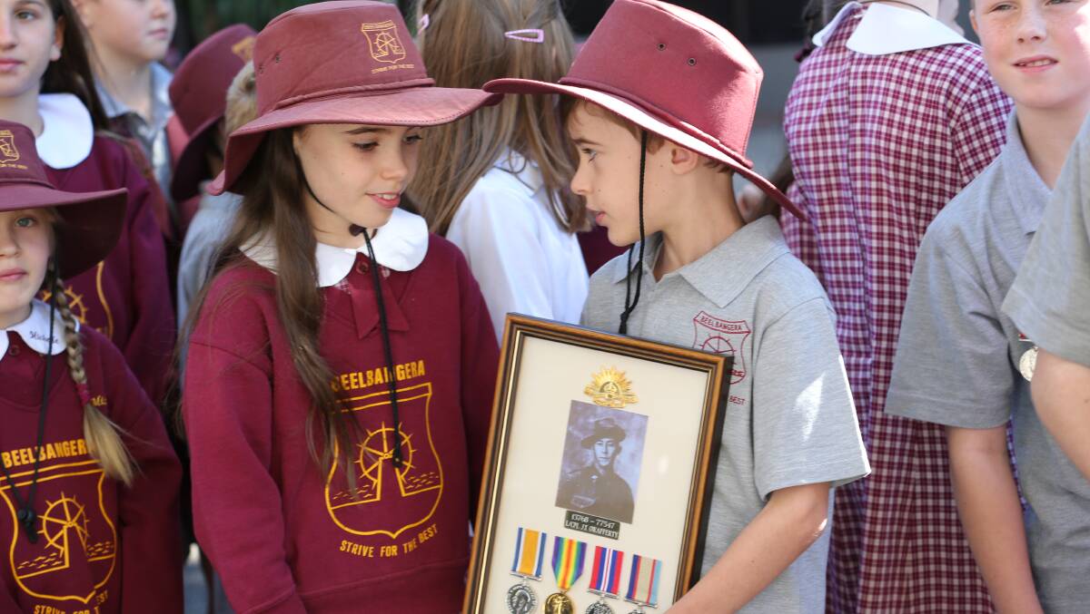 Anzac Day in Griffith. Dean, 9, and Sarah Casey, 10, wearing and carrying their great great grandfather's medals. Picture: Anthony Stipo 